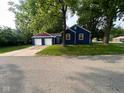 Home exterior showcasing a detached two-car garage and spacious driveway at 5704 N Keystone Ave, Indianapolis, IN 46220