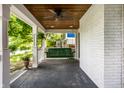 Cozy covered porch featuring a swing, ceiling fan, and painted brick wall at 5919 Central Ave, Indianapolis, IN 46220