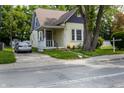 This home features a well-maintained yard, mature trees, and classic architecture with a welcoming front porch at 602 Prospect St, Indianapolis, IN 46203