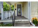 Welcoming front porch with steps and railing leading to the front door, enhanced by colorful flower plantings at 602 Prospect St, Indianapolis, IN 46203