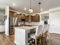 Modern kitchen featuring stainless steel appliances, a center island with seating, and pendant lighting at 628 Tess Blvd, Westfield, IN 46074