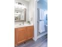 Well-lit half bathroom featuring wood cabinets, white countertops, and modern fixtures at 6480 E Coal Bluff Ct, Camby, IN 46113
