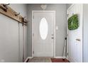 Inviting entryway with a white door, coat rack, and a wreath hanging in the background at 7 Pondview Ct, Brownsburg, IN 46112