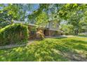 Angle view of exterior showing lawn, rock features, and two story construction at 750 Hillcrest Dr, Greenwood, IN 46142