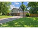 View of exterior with a basketball court, two story construction and a garage at 750 Hillcrest Dr, Greenwood, IN 46142