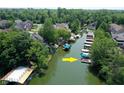 Aerial view of the property with lake access and private boat docks surrounded by lush greenery at 8069 Middle Bay Ln, Indianapolis, IN 46236