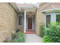 Close-up of a home's stone exterior and front entryway with a wooden door at 8069 Middle Bay Ln, Indianapolis, IN 46236