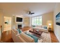 Bright living room with hardwood floors, fireplace, built-in shelves, and neutral furniture at 8069 Middle Bay Ln, Indianapolis, IN 46236