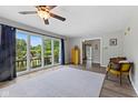 Cozy room filled with natural light, features hardwood floors, and access to a balcony through large sliding glass doors at 8435 Hilltop Ln, Martinsville, IN 46151