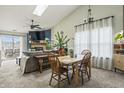 Bright and airy dining area featuring vaulted ceilings, fireplace, and lots of natural light at 8526 Country Meadows Dr, Indianapolis, IN 46234