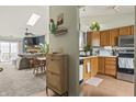 Inviting open-concept home featuring a kitchen with wood cabinets adjacent to the dining and living areas at 8526 Country Meadows Dr, Indianapolis, IN 46234