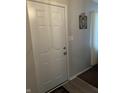 Interior view of a white front door with a decorative 'Walk by Faith' sign and light switch at 9016 Neptune Dr, Indianapolis, IN 46229