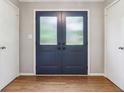 View of a double door entryway with sidelights, a wood floor and white trim at 9256 Colgate St, Indianapolis, IN 46268