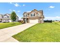 A view of a two-story home with neutral siding, a two-car garage, and a neatly maintained lawn at 937 Maple Stone Dr, Greenwood, IN 46143