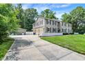 Traditional home with a three car garage, long driveway, and pristine landscaping at 9650 Copley Dr, Carmel, IN 46290