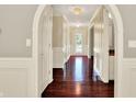 Elegant foyer featuring hardwood floors, striped wallpaper, and decorative lighting at 9650 Copley Dr, Carmel, IN 46290