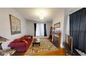 Bright living room featuring hardwood floors, a decorative rug, fireplace, and comfortable seating at 1002 N New Jersey St, Indianapolis, IN 46202