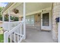 Inviting front porch adorned with hanging flower baskets, offering a warm welcome at 1020 N Ritter Ave, Indianapolis, IN 46219