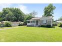 Landscaped front yard of a cozy home, featuring mature trees and a well-maintained lawn at 1020 N Ritter Ave, Indianapolis, IN 46219