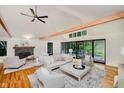 Spacious living room boasts a fireplace, hardwood floors, and sliding glass doors leading to the deck at 1065 E 76Th St, Indianapolis, IN 46240