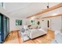 Bright and airy living room with vaulted ceilings, wooden beams, hardwood floors, and large windows at 1065 E 76Th St, Indianapolis, IN 46240