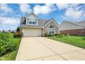 Charming single-Gathering home featuring a brick facade, attached garage, and well-manicured lawn at 10712 Cardinal Cir, Indianapolis, IN 46231