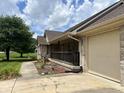 Charming brick home with a covered porch and an attached two-car garage showcasing curb appeal at 1082 E County Road 400 S, Clayton, IN 46118