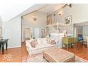 Bright and airy living room with hardwood floors, tall ceilings, and an elegant staircase at 11030 Brentwood Ave, Zionsville, IN 46077