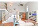 Inviting living area features high ceilings, hardwood floors, and staircase with charming accents at 11030 Brentwood Ave, Zionsville, IN 46077