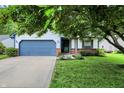 Charming single Gathering home featuring an attached garage and mature landscaping in a suburban neighborhood at 11518 Cherry Blossom W Dr, Fishers, IN 46038