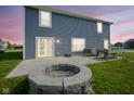Private backyard featuring a patio area with a fire pit and grass at 1278 W Limestone Way, Fortville, IN 46040