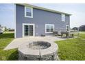 Private backyard featuring a patio area with a fire pit and grass at 1278 W Limestone Way, Fortville, IN 46040
