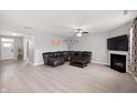 Open concept living room with recessed lighting, hardwood floors, fireplace and a comfy sectional at 1312 Donald Pass, Greenwood, IN 46143