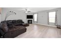 Spacious living room with hardwood floors, fireplace, recessed lights, ceiling fan and a comfy sectional at 1312 Donald Pass, Greenwood, IN 46143