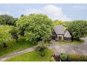 Aerial view of a unique home with a stone and wood exterior, complemented by mature trees and landscaping at 16714 Oak Rd, Westfield, IN 46074