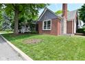 Charming home with a manicured lawn and traditional architectural details at 1702 Kessler Blvd E Dr, Indianapolis, IN 46220