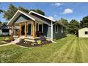 Landscaped front yard, and covered porch perfect for enjoying quiet moments outside at 1818 Broadway St, Anderson, IN 46012