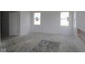 Spacious living room with neutral walls, two windows, and new construction, ready for personalization at 1890 Victor Higgins Dr, Shelbyville, IN 46176