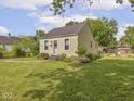 View of home's exterior showcasing the yard, siding, and landscaping on a sunny day at 2018 N Rochester Ave, Indianapolis, IN 46222