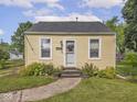 Picture of the front of a well maintained home with sidewalk and decorative landscaping at 2018 N Rochester Ave, Indianapolis, IN 46222