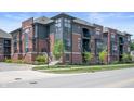 Modern townhome featuring brick and gray siding with landscaped front entrances on corner lot at 205 Poplar St, Westfield, IN 46074
