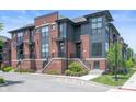 Modern townhome featuring brick and gray siding with landscaped front entrances at 205 Poplar St, Westfield, IN 46074