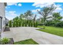 Spacious backyard featuring a large concrete patio area lined with trees and a well-maintained lawn at 2074 Tompkins Dr, Westfield, IN 46074