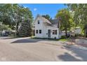 Exterior shot of a cute two-story home, showcasing curb appeal and its setting within a residential street at 247 N 14Th St, Noblesville, IN 46060