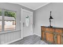 Warm and inviting home entryway with a decorative front door, stylish flooring, and designer cabinet at 247 N 14Th St, Noblesville, IN 46060