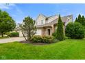 Well-maintained townhome featuring an attached two-car garage, lush lawns, and mature landscaping in a lovely community at 255 Bastion Pl # Apt D, Avon, IN 46123