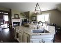 Open concept kitchen with granite countertops, modern island sink, and views of the living area at 2825 E 216Th St, Cicero, IN 46034