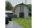 View of the back building featuring a gravel road and grassy lawn at 2914 E Blue Ridge Orch, Shelbyville, IN 46176