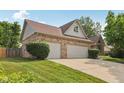 Lovely brick home featuring a three-car garage, well-maintained lawn and tasteful shrubbery at 3430 Whalen Ave, Indianapolis, IN 46227