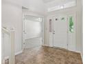 Bright foyer with tile floor, transom window over front door, and view into spacious living area at 3430 Whalen Ave, Indianapolis, IN 46227